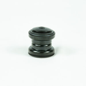 Pièce cylindrique noire sur fond blanc.